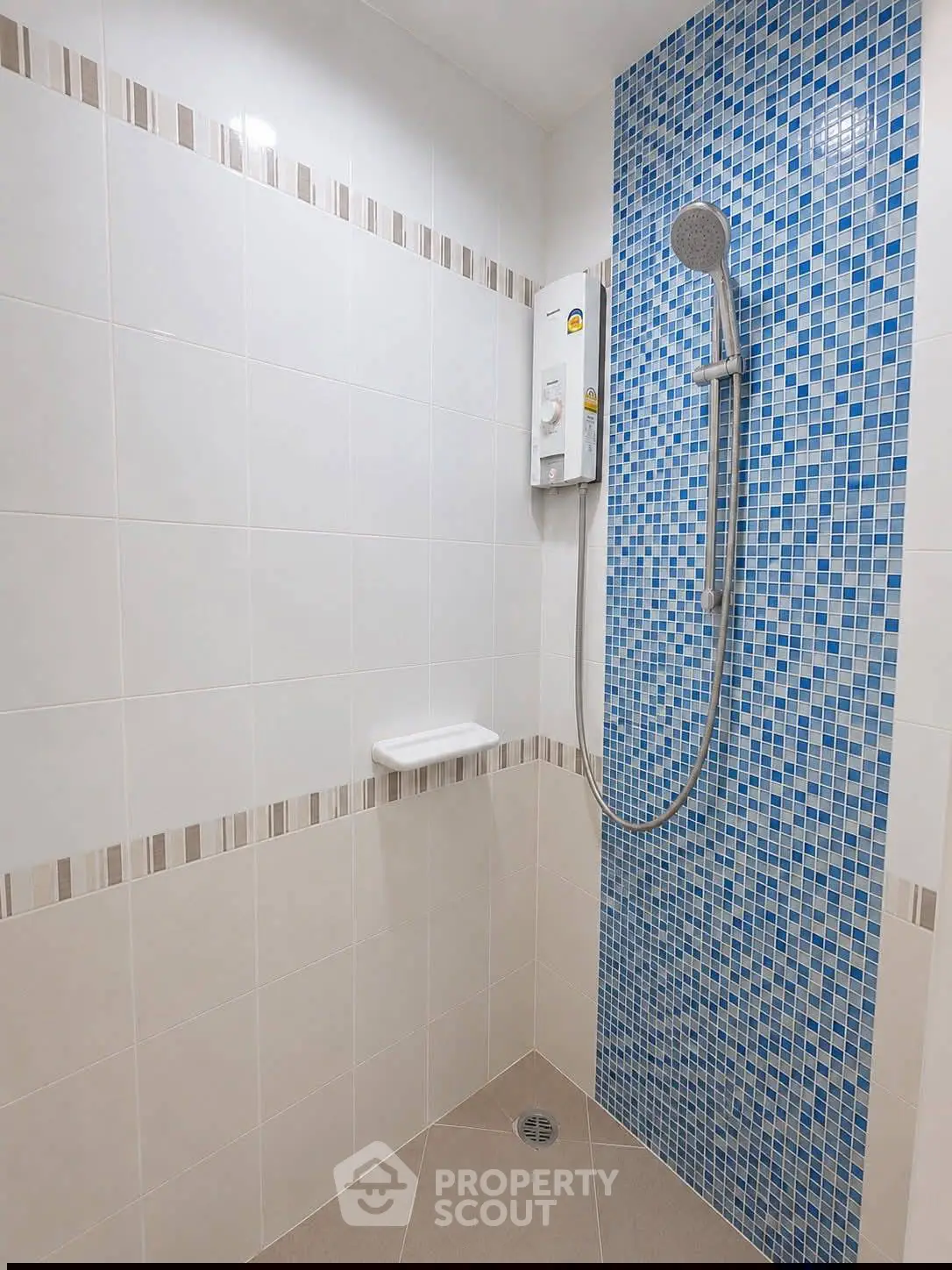 Modern bathroom shower with blue mosaic tiles and sleek fixtures