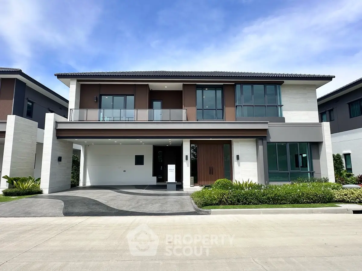 Modern two-story house with sleek design and spacious driveway