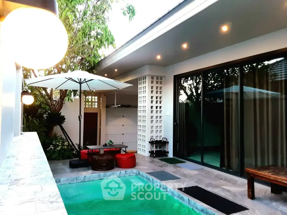Luxurious modern villa with private pool and stylish outdoor seating area.