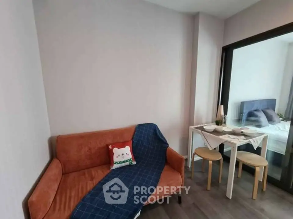 Cozy living room with modern decor and adjacent dining area in a stylish apartment.