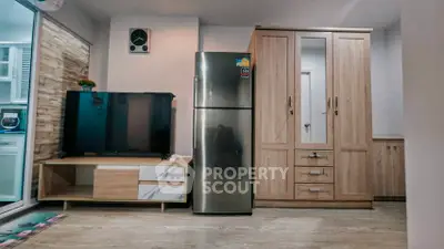Modern living room with sleek fridge and stylish wooden furniture