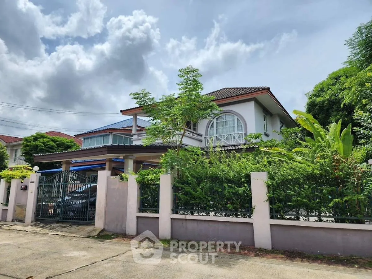 Charming two-story house with lush garden and spacious driveway in serene neighborhood.