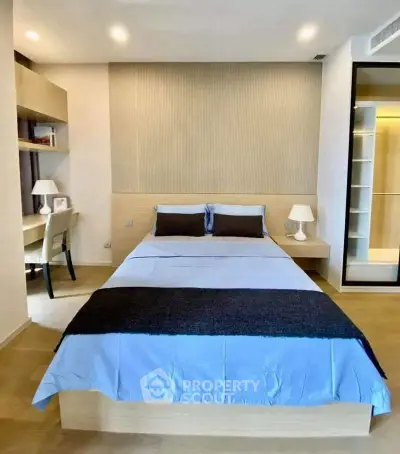 Modern bedroom with stylish decor and built-in storage, perfect for a cozy and organized living space.