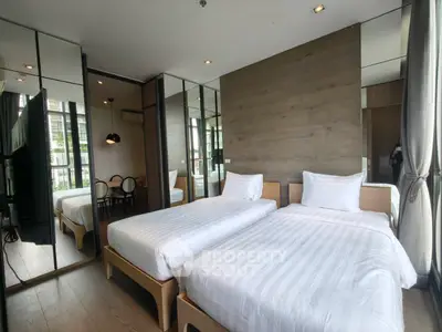 Modern bedroom with twin beds and mirrored walls in stylish apartment