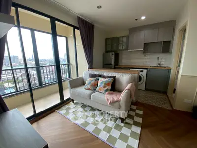 Modern living room with balcony view, cozy sofa, and stylish kitchen area.