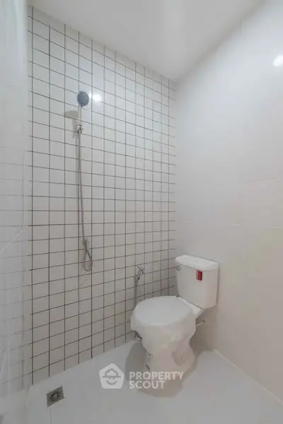 Modern minimalist bathroom with white tiles and shower