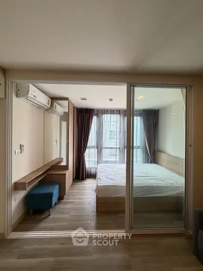 Modern bedroom with glass sliding door and natural light