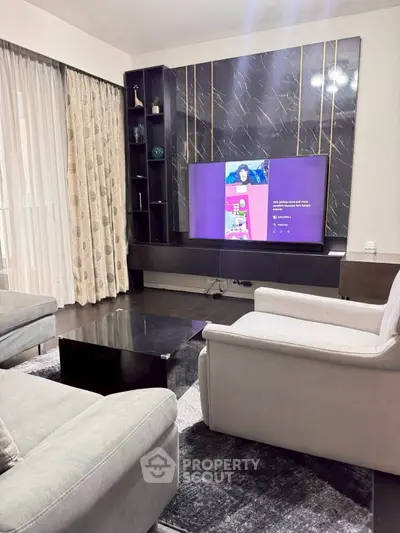 Elegant living room with modern decor and large TV setup