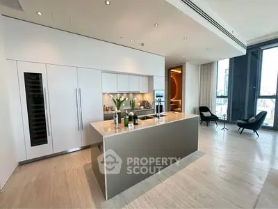 Luxurious modern kitchen with sleek island and open layout in high-rise apartment.