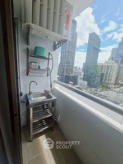 High-rise balcony with city view and utility sink, perfect for urban living.
