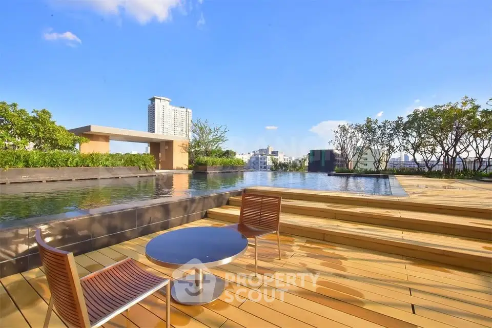 Luxurious rooftop pool with stunning city views and modern seating area.