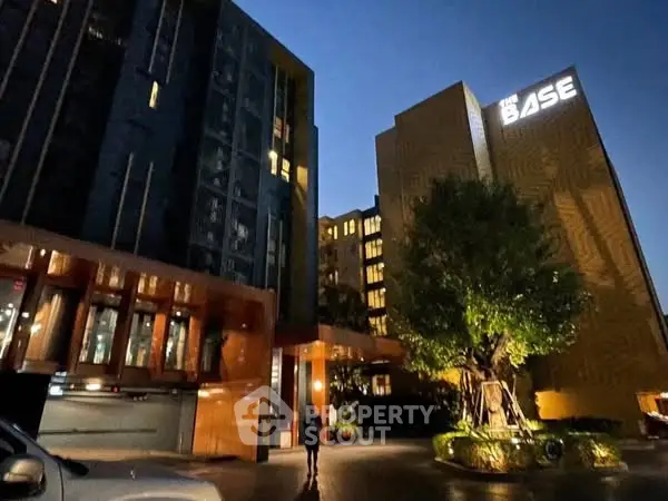 Modern urban residential building with illuminated facade at night