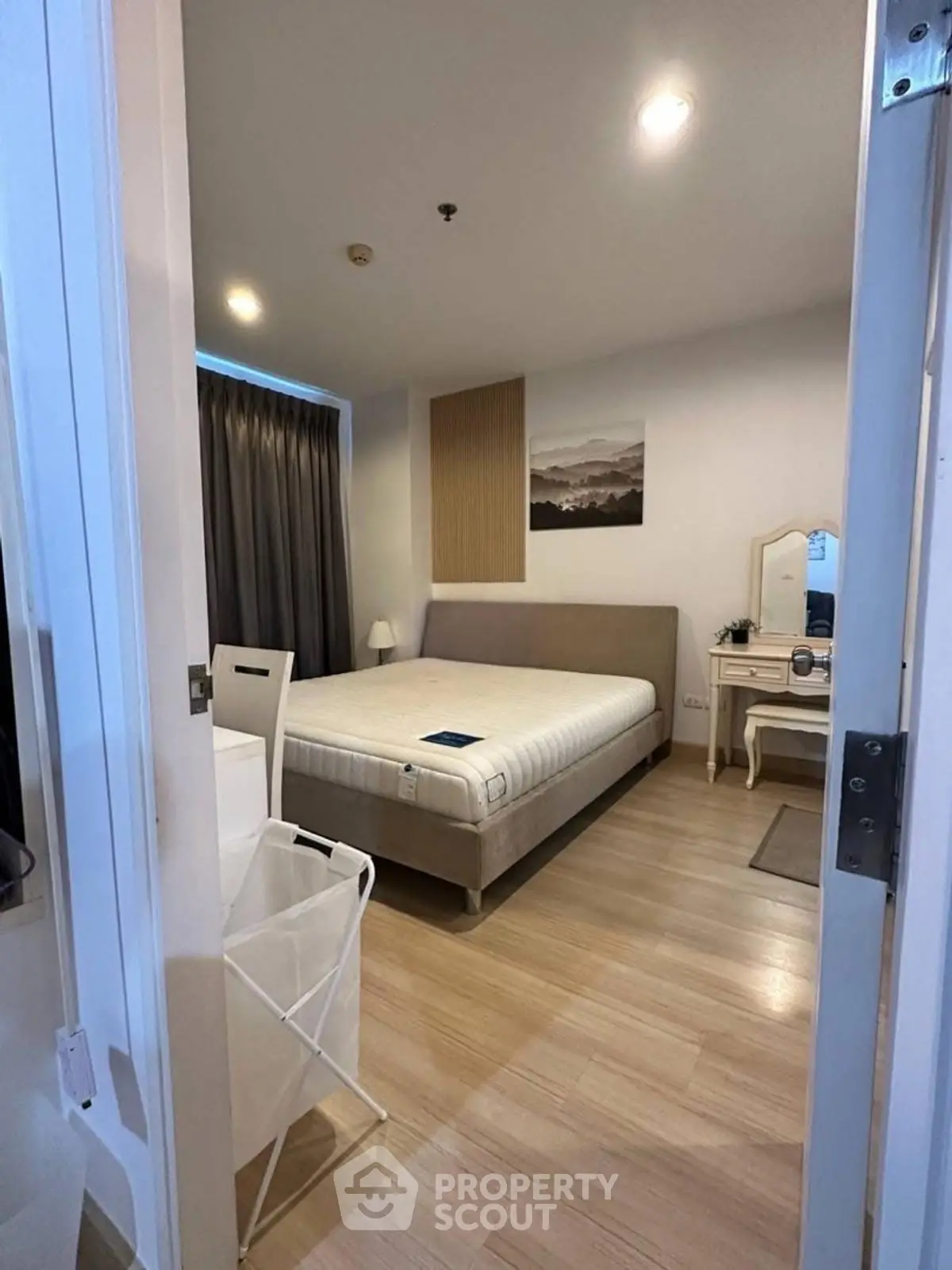 Cozy bedroom with modern decor and ample natural light, featuring a comfortable bed and stylish furniture.