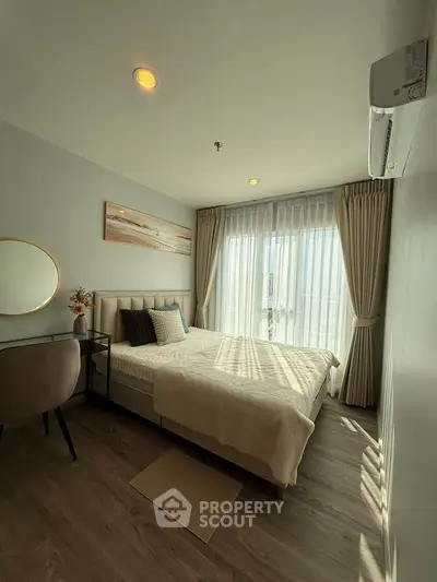 Modern bedroom with natural light, stylish decor, and cozy ambiance.