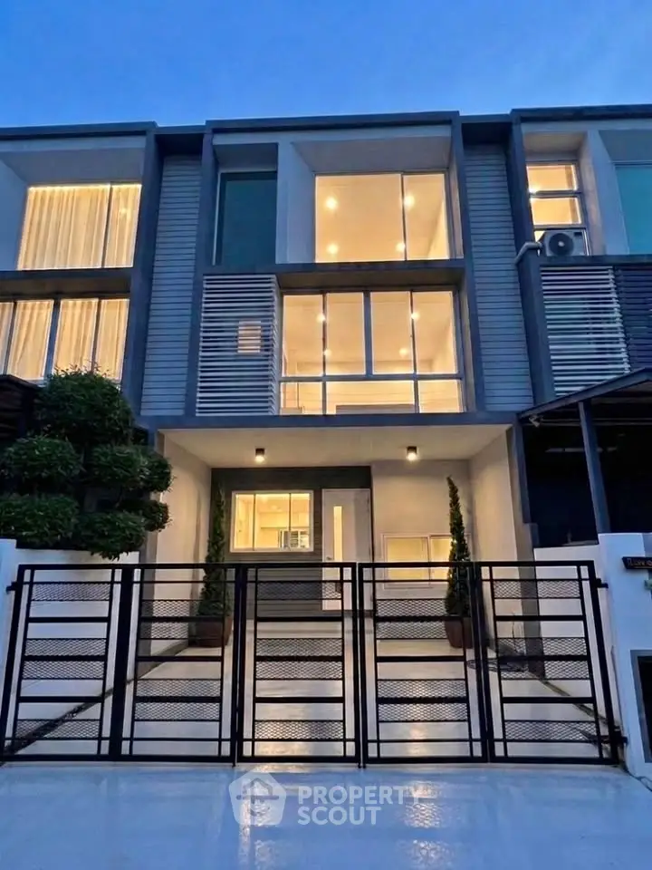 Modern townhouse exterior with sleek design and large windows, perfect for urban living.