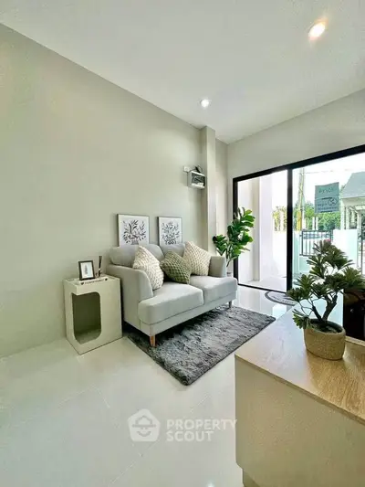Modern living room with cozy sofa and large window view