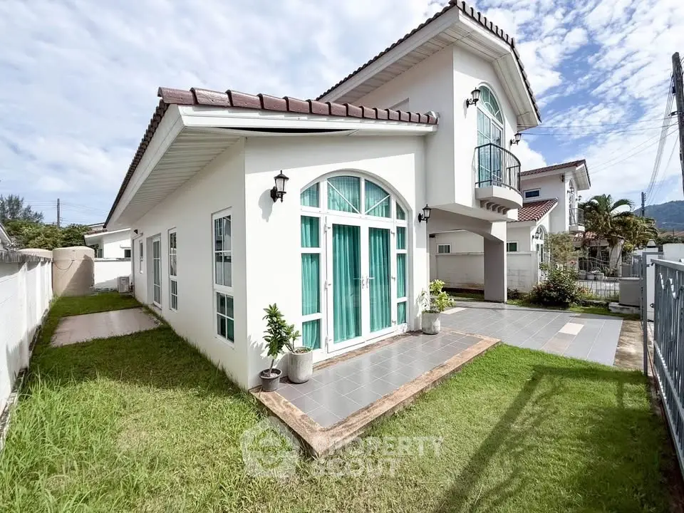 Stunning modern house with large windows and lush green lawn, perfect for family living.