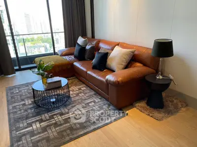 Stylish living room with leather sofa and city view balcony in modern apartment