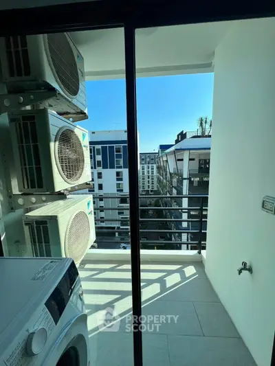 Modern apartment balcony with air conditioning units and city view