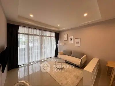 Modern living room with cozy sofa and large window for natural light