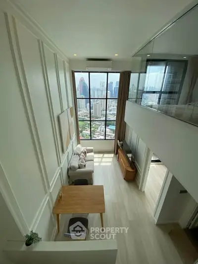 Modern loft apartment with high ceilings and stunning city view, featuring stylish living area and large windows.