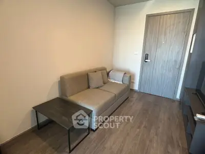 Modern living room with cozy gray sofa and sleek wooden flooring