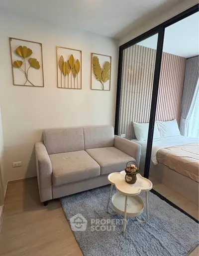 Cozy living room with modern decor and glass partition to bedroom