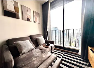 Stylish living room with modern decor and city view balcony, perfect for urban living.
