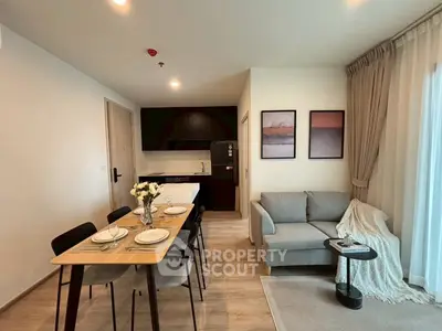 Modern open-layout living room with dining area and cozy sofa, perfect for urban living.