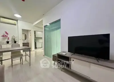 Modern living room with sleek furniture and open kitchen layout, perfect for urban living.