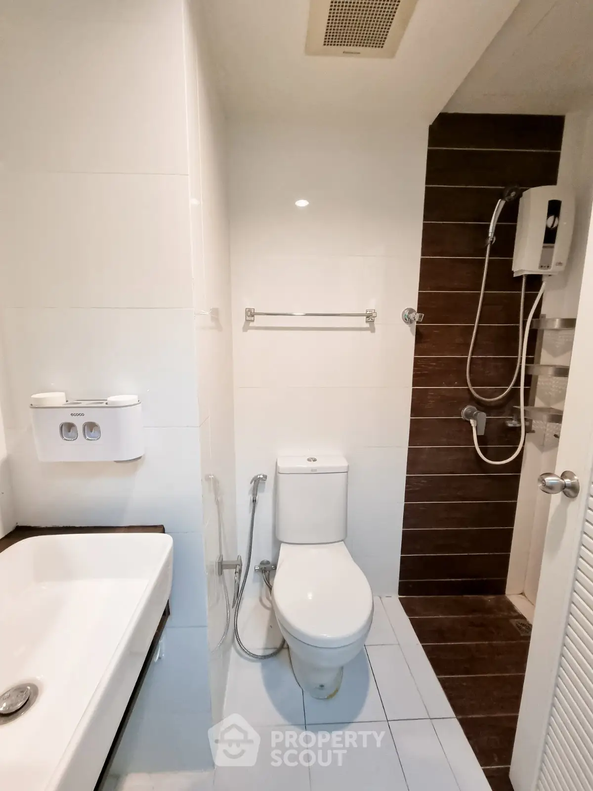 Modern bathroom with sleek fixtures and shower in contemporary apartment.