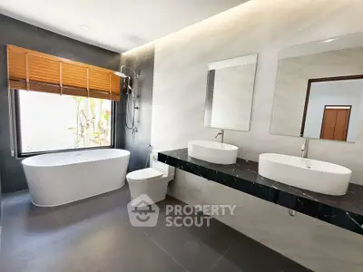 Luxurious modern bathroom with dual sinks and freestanding bathtub
