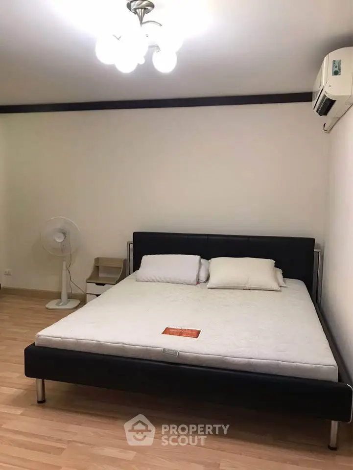 Spacious bedroom with modern bed and air conditioning