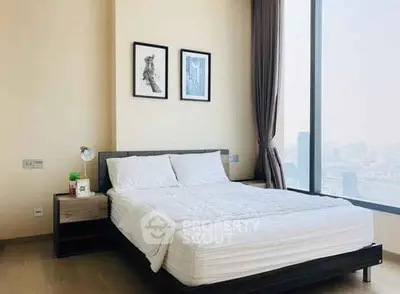 Luxurious bedroom with floor-to-ceiling windows offering stunning city views.