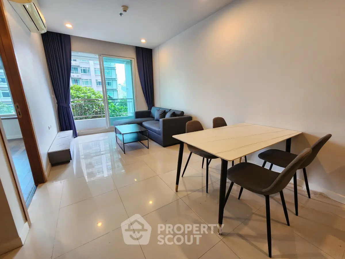 Modern living room with sleek furniture and large windows offering a bright and airy atmosphere.