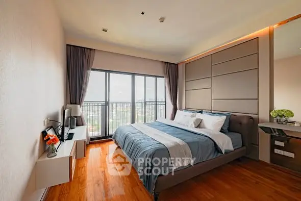 Spacious modern bedroom with large window and elegant decor