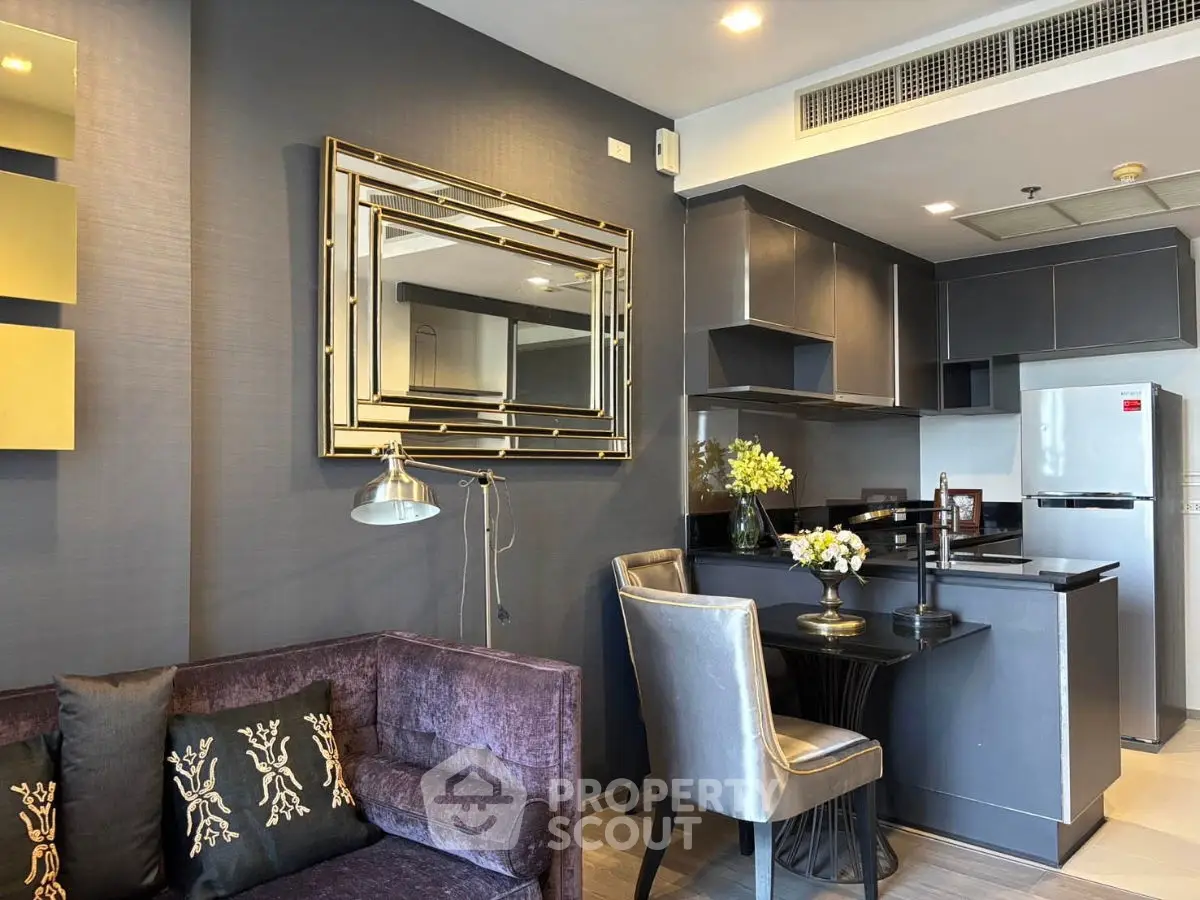 Modern living room with stylish decor and open kitchen layout in a luxury apartment.