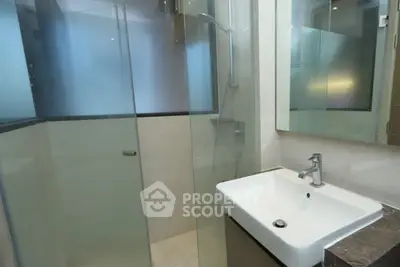 Modern bathroom with glass shower and sleek sink design