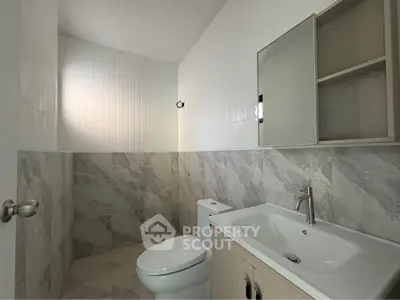 Modern bathroom with sleek fixtures and marble tiles