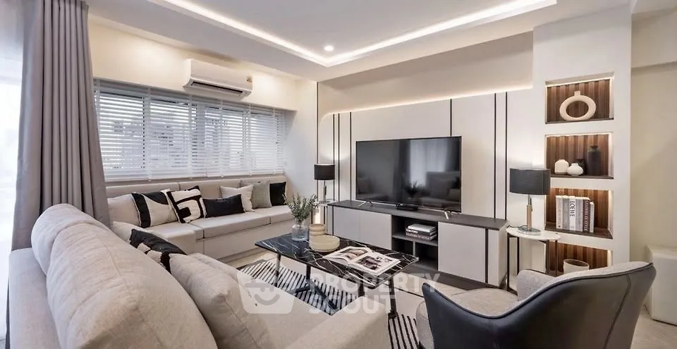 Modern living room with stylish decor and large TV setup