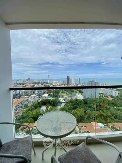 Stunning balcony view overlooking cityscape and ocean, perfect for relaxation.