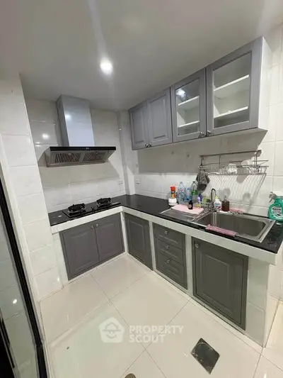 Modern kitchen with sleek cabinetry and gas stove in a compact layout