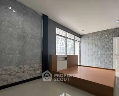 Spacious bedroom with modern design and large windows for natural light.
