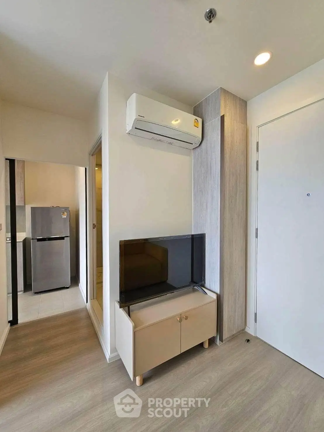 Modern apartment interior with air conditioning and sleek furniture, showcasing a compact yet stylish living space.