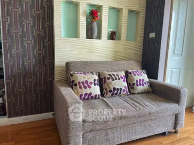 Chic living room with textured walls, stylish sofa, and elegant wooden flooring, perfect for modern living.
