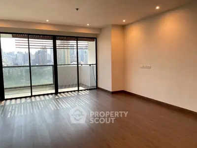 Spacious empty living room with large windows and city view, perfect for customization.
