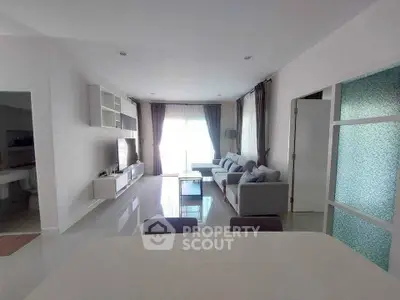 Spacious modern living room with sleek furniture and natural light