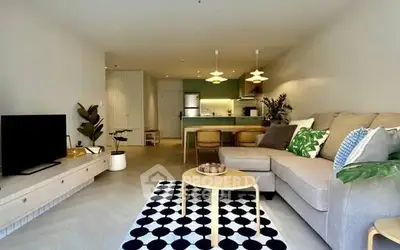 Modern living room with stylish decor and open kitchen layout in a cozy apartment.