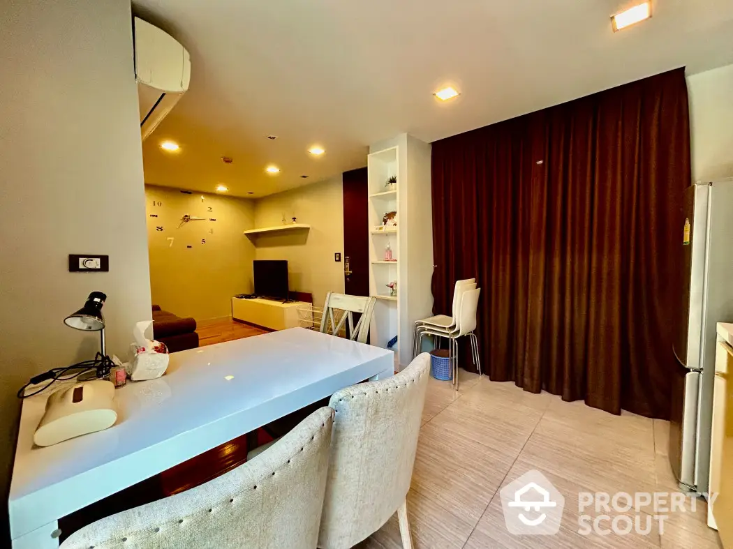 Modern living room with stylish decor and open layout, featuring a cozy seating area and elegant dining space.