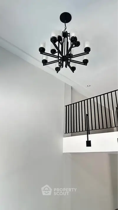 Modern interior with elegant chandelier and sleek railing design